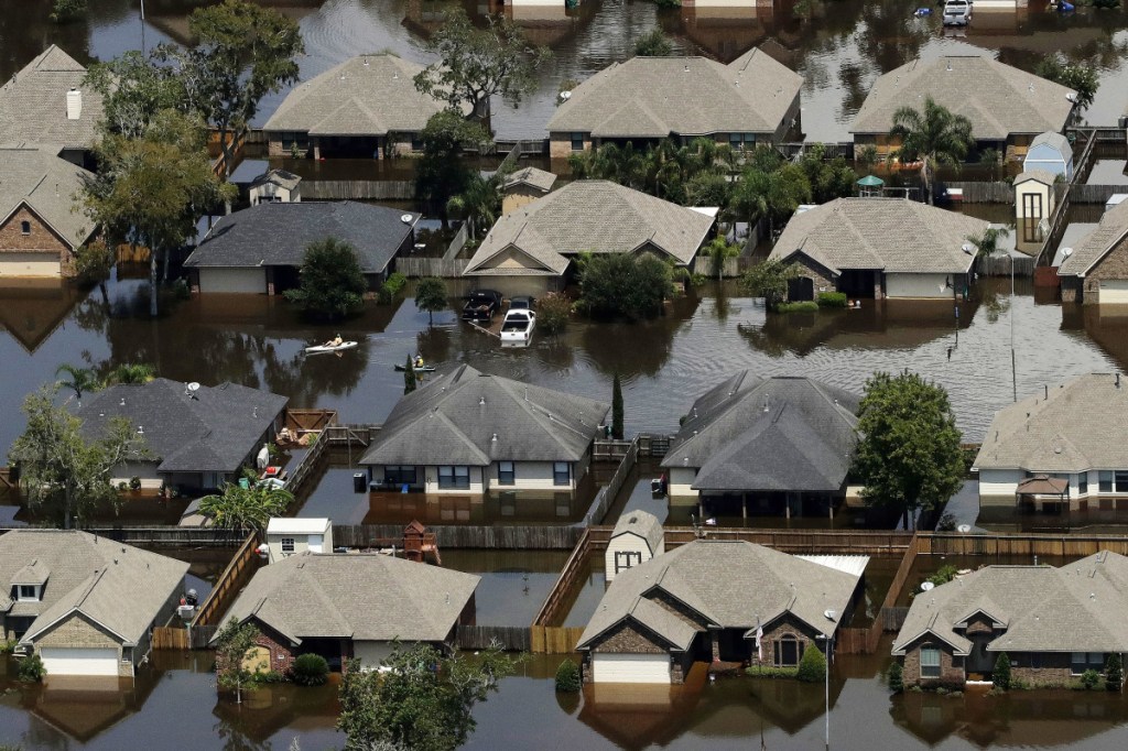Homes are surrounded by water from the flooded Brazos River in the aftermath of Hurricane Harvey on Sept. 1, 2017, in Freeport, Texas. According to a study released on Wednesday, tropical cyclones around the world are moving slightly slower over land and water, dumping more rain as they stall, just as Hurricane Harvey did. Associated Press/Charlie Riedel