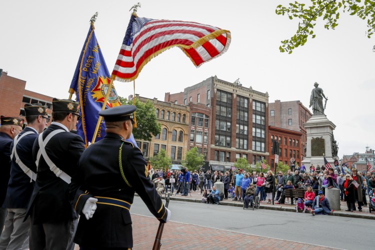The VFW Honor Guard stands at attention as a crowd awaits speakers after Portland's Memorial Day parade May 28. A reader says a separate tribute to veterans in Scarborough deserved coverage.