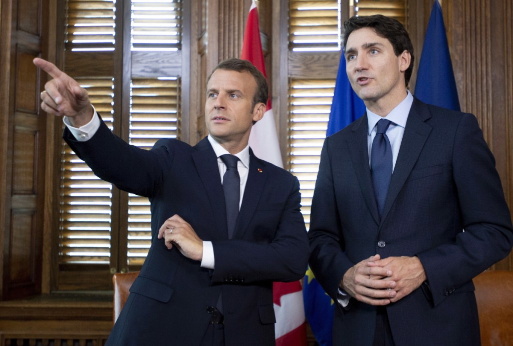 France's President Emmanuel Macron, left, speaks with Canada's Prime Minister Justin Trudeau before a meeting in Trudeau's office in Ottawa, Ontario, on Wednesday.
