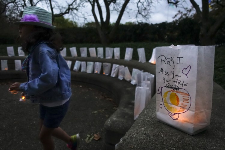 Paper bags with messages for the deceased line a suicide prevention walk in Cincinnati in 2017. Two recent celebrity deaths spur a reader familiar with mental illness  to repudiate the stigma attached.