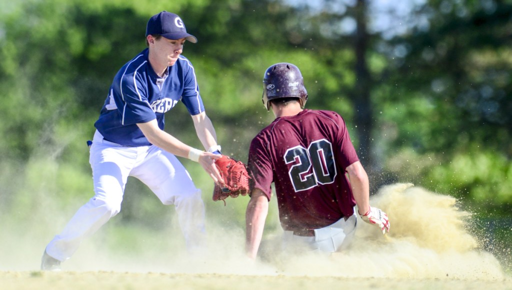 Greenville's Noah Pratt is too late with the tag as Richmond's Justin Vachon (20) slides safely into second during a Class D South semifinal on Friday in Richmond.