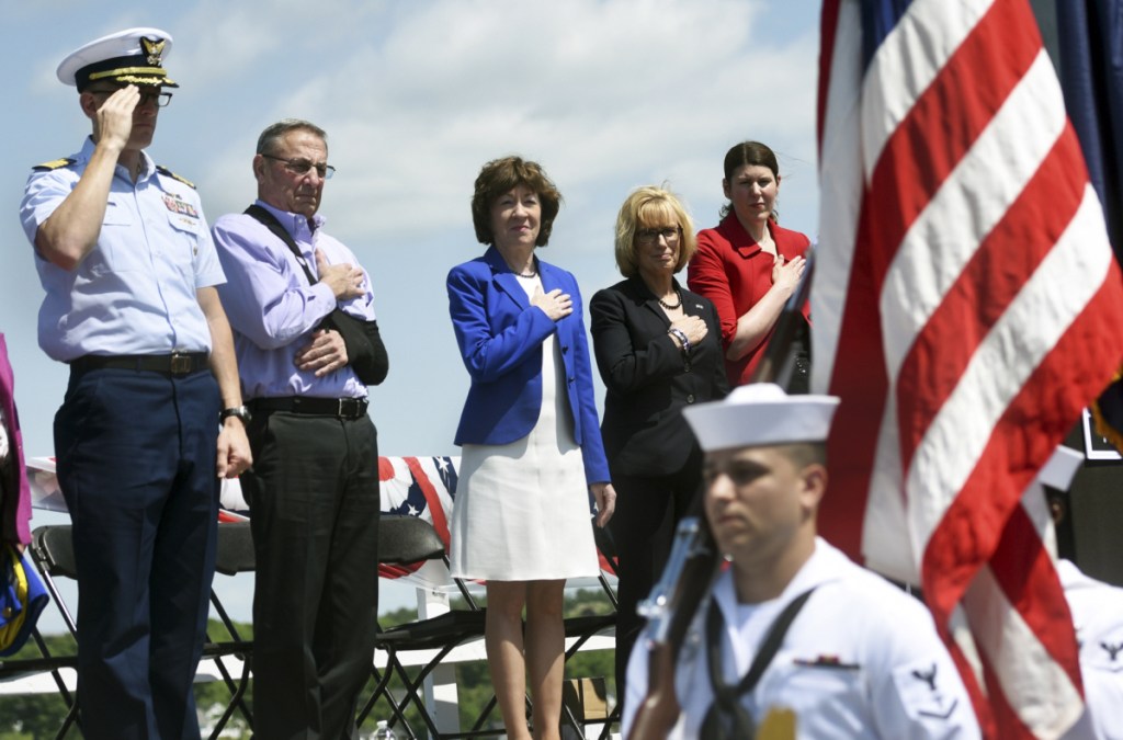 Dignitaries put their hands over their hearts and salute as the colors are presented Friday during the Sarah Mildred Long Bridge Walk Celebration. From left are Coast Guard Capt. Brian LeFebvre, Maine Gov. Paul LePage, Maine Sen. Susan Collins, New Hampshire Sen. Maggie Hassan and New Hampshire Transportation Commissioner Victoria Sheehan.