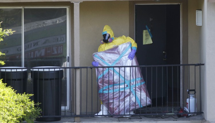A hazardous-material cleaner removes a wrapped item in 2014 from the Dallas apartment where Thomas Eric Duncan, the first Ebola patient diagnosed in the United States, stayed. As the deadly virus re-emerges in the Congo, the risk of falling into apathy is very real in Washington.