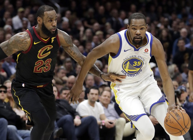 Kevin Durant, right, will sign a two-year contract to remain with Golden State, according to a person with knowledge of the deal, with the caveat that the contract will have an option and allow him to return to free agency next summer. Meanwhile, LeBron James, left, has everyone waiting for his decision.