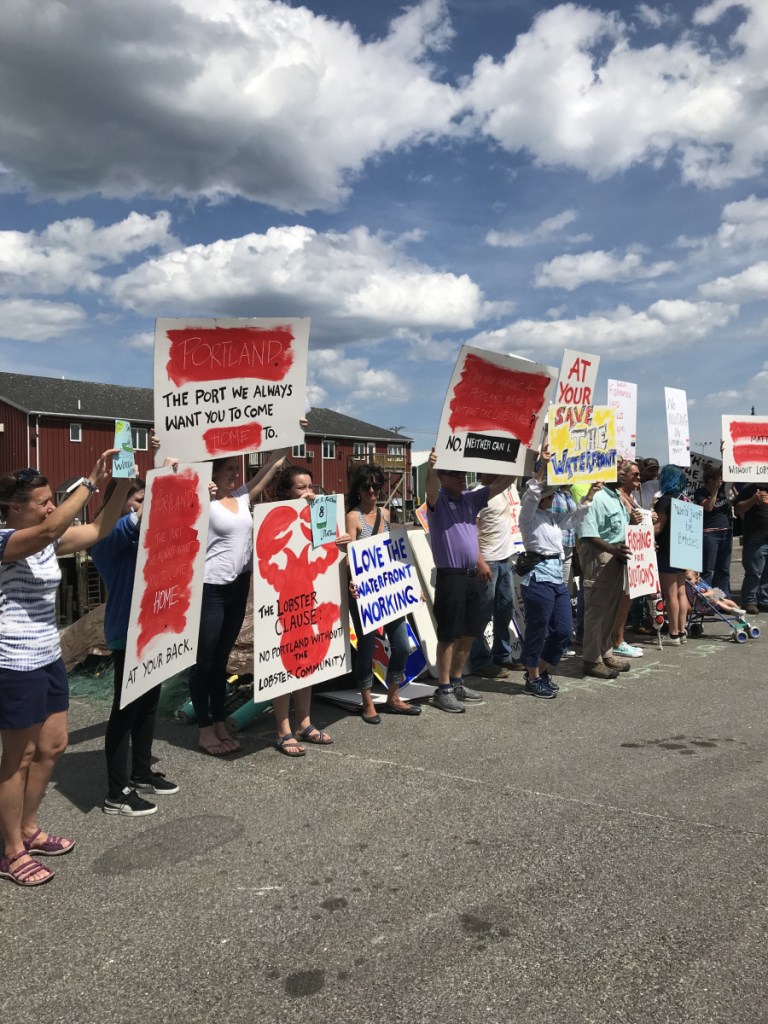 Fishermen, lobstermen and others protest Saturday at Union Wharf in Portland about planned development on the city's waterfront that they fear could leave the working waterfront behind. Staff photo by Eric Russell