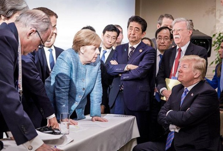 German Chancellor Angela Merkel and other G-7 leaders speak with President Trump as he prepares to leave early from the summit Saturday. 