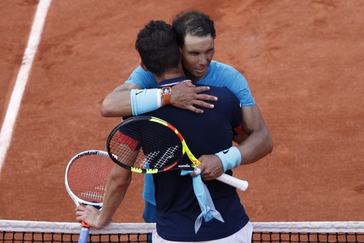 Rafael Nadal hugs Dominic Thiem after defeating him in the French Open men's final. Nadal won 6-4, 6-3, 6-2.