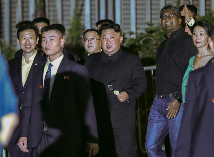 North Korea leader Kim Jong Un, center, is escorted by his security delegation as he visits Marina Bay in Singapore on Monday prior to a summit with President Trump.