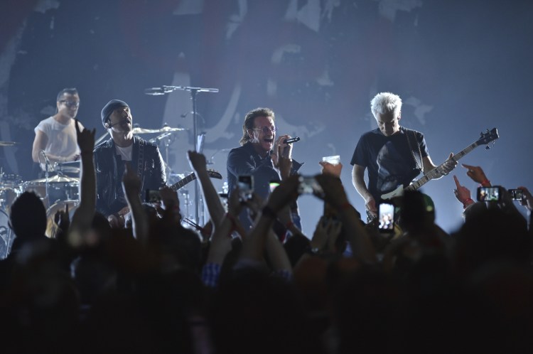 From left, Larry Mullen Jr., The Edge, Bono and Adam Clayton of U2 perform during a concert at the Apollo Theater on Monday night in New York.