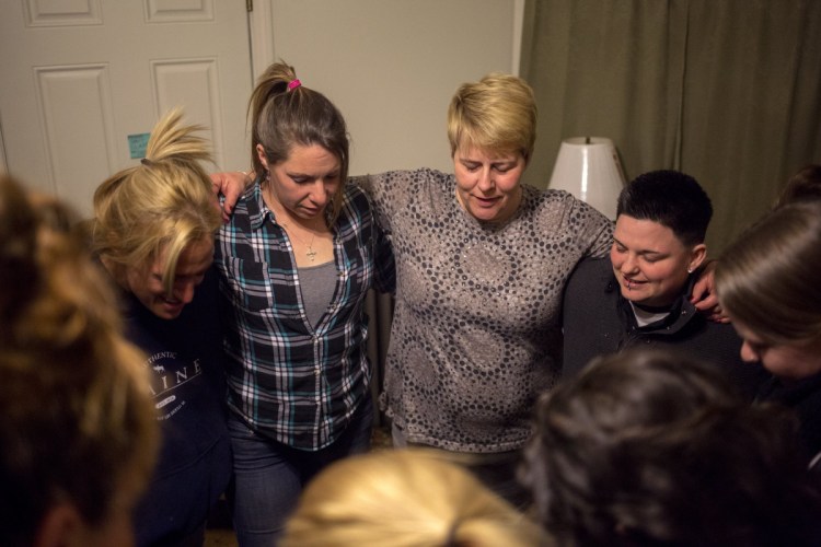 Nichole Curtis, center, who runs a Portland sober house, takes part in the prayer at the end of a March 2017 meeting. A bill before the U.S. House would allow cities to bar those in recovery from cohabitating in residential neighborhoods.
