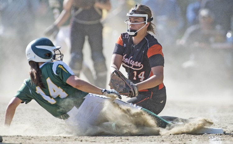Ashley Child of Oxford Hills slides safely into third base before Skowhegan's Lindsey Warren can apply the tag during the Class A North championship game Tuesday at Winslow High. Oxford Hills won, 7-3.