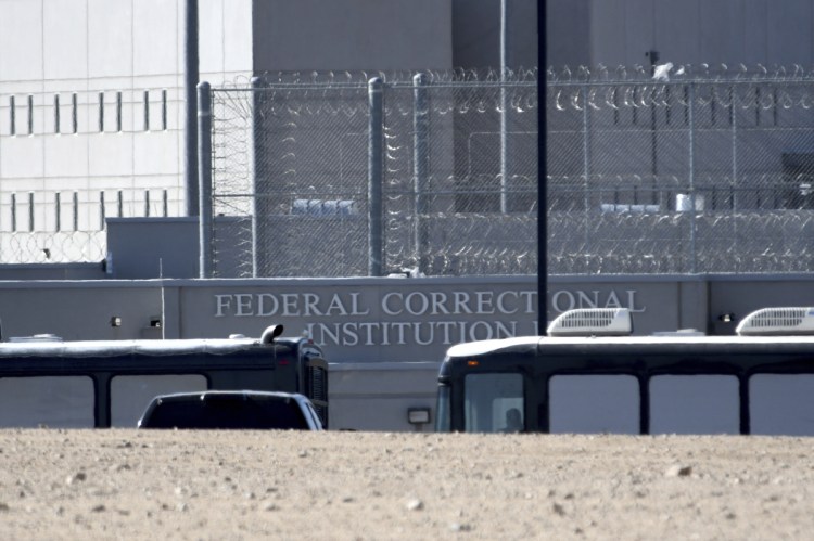 Homeland Security buses enter the Federal Correctional Institution in Victorville, Calif., on Friday. Parents arrested at the U.S.-Mexico border are being held at federal prisons while their children are filling up separate shelters. Unaccompanied children may soon find themselves in tent cities.