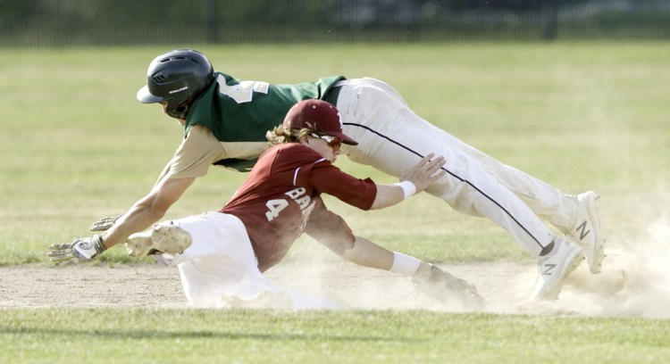Rod Bean of Oxford Hills dives over Bangor infielder Zach Ireland but is tagged out on a steal attempt in the Class A North baseball final Tuesday.