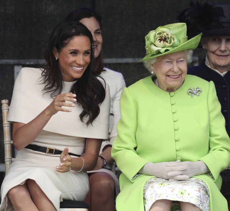 Britain's Queen Elizabeth II and Meghan, the Duchess of Sussex, attend the opening of the new Mersey Gateway Bridge in Widnes, northwestern England.