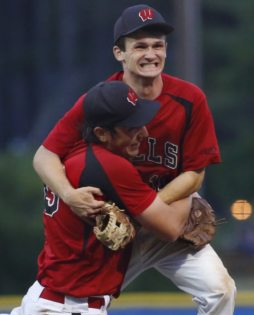 Wells pitcher Cam Cousins, front, and shortstop Liam Bell celebrate after an 8-3 win over Greely in the Class B South baseball final Wednesday night. The Warriors face Brewer in the state championship game on Saturday.