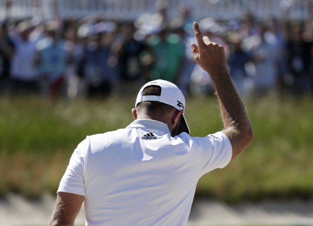Associated Press/Julio Cortez 
 Dustin Johnson reacts after sinking a shot from the bunker for par on the seventh hole during the first round of the U.S. Open Golf Championship, Thursday in Southampton, N.Y.