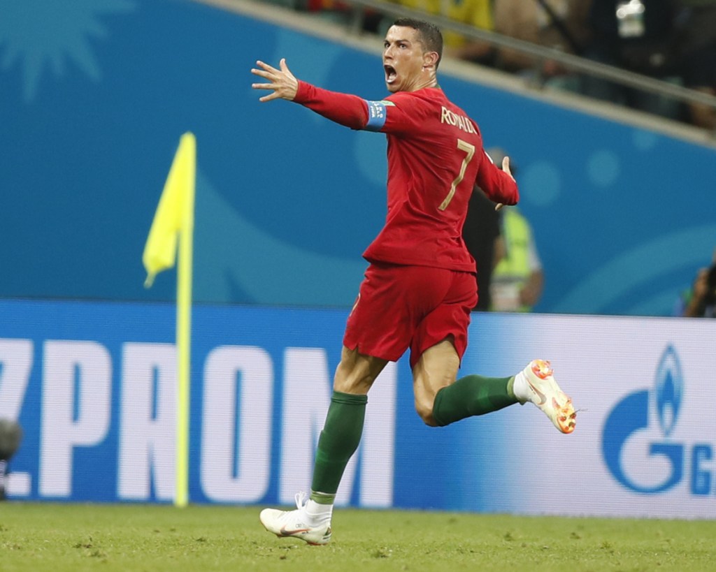 Portugal's Cristiano Ronaldo celebrates after scoring one of his three goals in Portugal's 3-3 tie with Spain on Friday in Sochi, Russia.