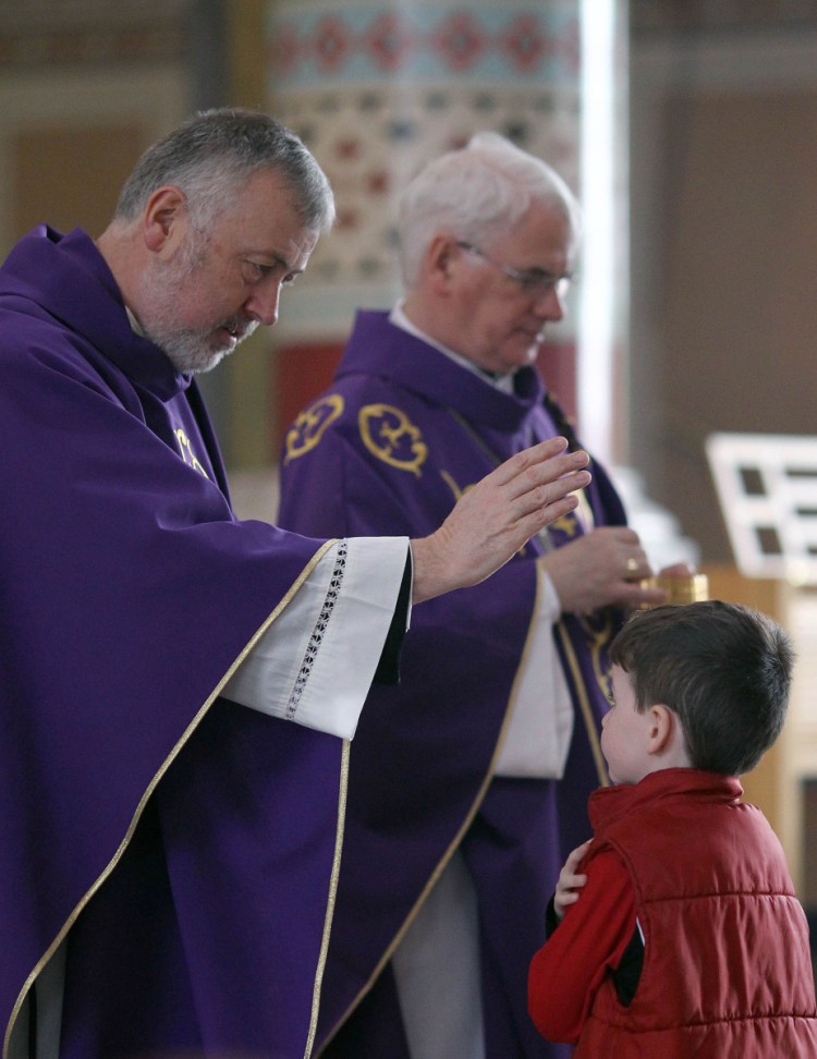 A priest blesses a boy at St. Peter's Roman Catholic Cathedral in West Belfast, Northern Ireland, in 2010. The World Meeting of Families will be held Aug. 21-26 in Dublin.