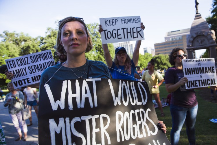 Demonstrators protest against the separation of immigrant families Thursday in Austin, Texas, where the government plans to open a temporary shelter for unaccompanied immigrant children. On Friday, the government reported that nearly 2,000 children have been separated from their families since April 19.