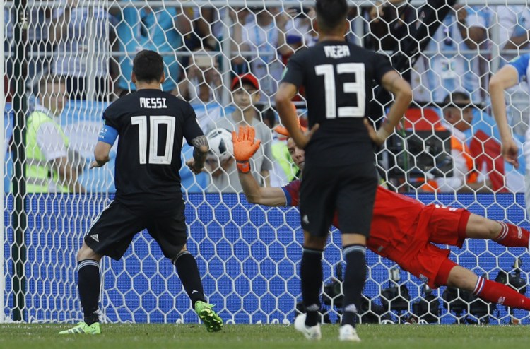Iceland goalkeeper Hannes Halldorsson stops the penalty kick off the foot of Argentina's Lionel Messi.