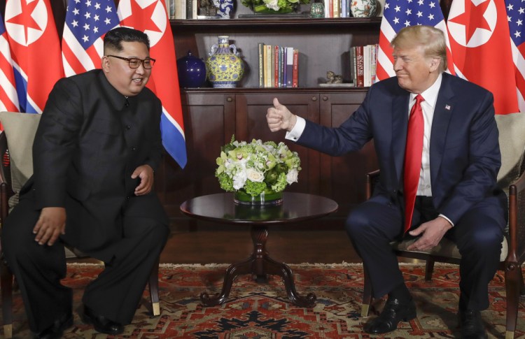 President Trump gives North Korean leader Kim Jong Un a thumbs-up during their meeting at a resort on Sentosa Island in Singapore on Tuesday.