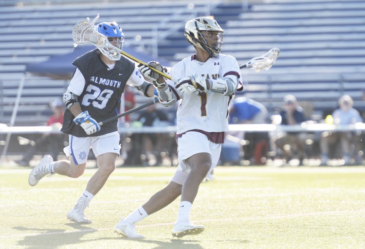 Thornton Academy's C.J. LaBreck takes a shot on goal as Falmouth's Riley Reed moves in on defense during the Trojans' 14-12 win in the Class A state championship game Saturday at Fitzpatrick Stadium.