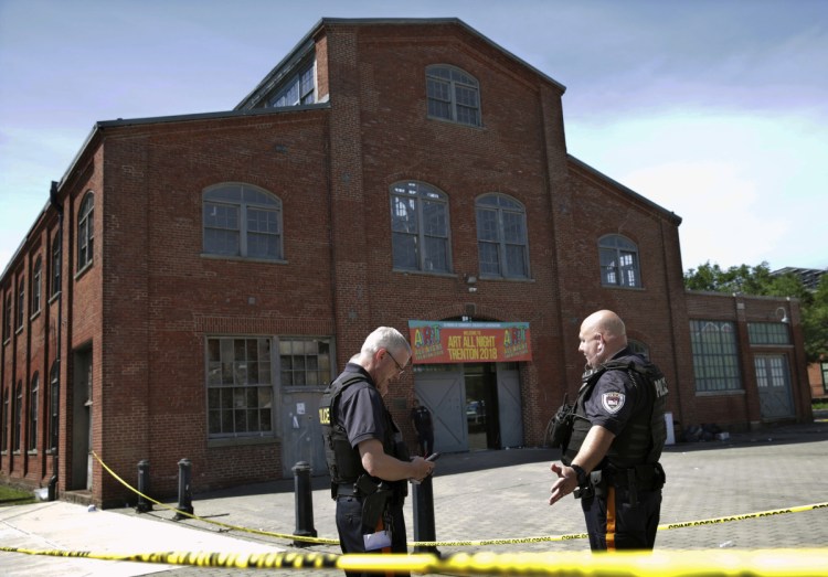 Police stand guard Sunday outside the warehouse building where the Art All Night Trenton 2018 festival was held. Gunfire erupted there about 2:45 a.m., leaving one dead and at least 20 injured in a scene of panic.