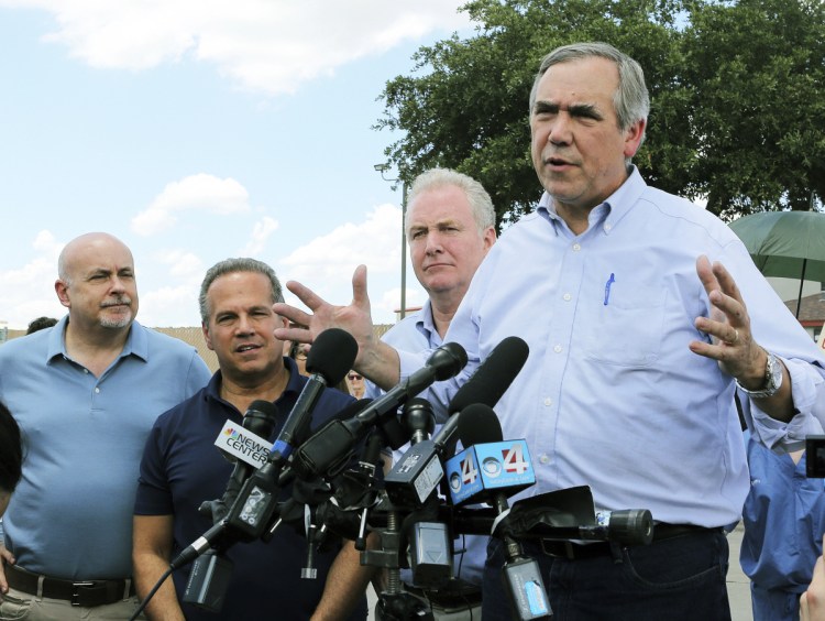 U.S. Sen. Jeff Merkley, D-Oregon, speaks to the media in front of the U.S. Customs and Border Protection's Centralized Processing Center in McAllen, Texas, on Sunday. Looking on are Sen. Chris Van Hollen, D-Md., center; U.S. Rep. David Cicilline, D-R.I., and U.S. Rep. Mark Pocan, D-Wis., left.