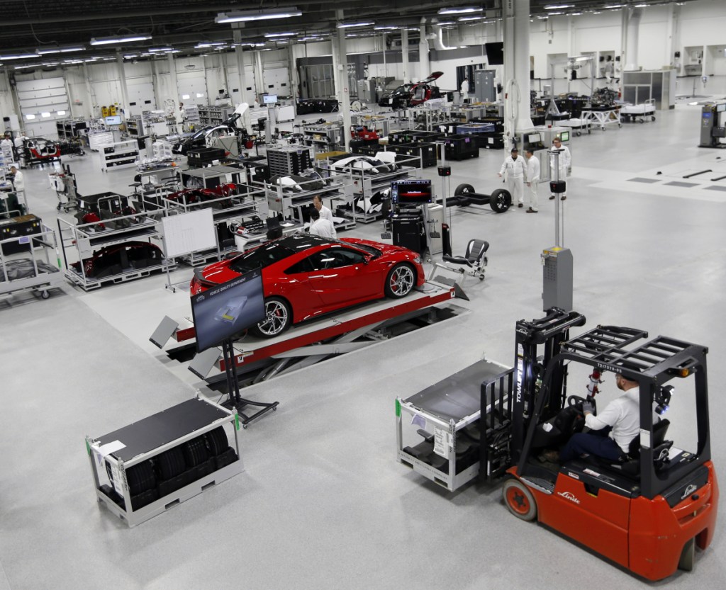 Technicians work on Honda Acura's next-generation supercar, the NSX, at its Performance Manufacturing Center in Marysville, Ohio. If President Trump delivers on threats to slap 25 percent tariffs on imported automobiles and parts, experts say it will cut auto sales and cost jobs in the U.S., Canada and Mexico.