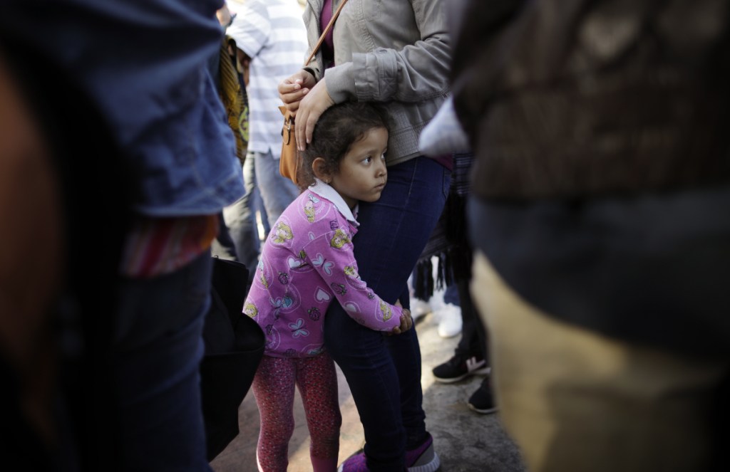 Nicole Hernandez, of the Mexican state of Guerrero, holds her mother June 13 as they wait in Tijuana to request political asylum in the U.S. A reader says separating children from their immigrant parents at the border is not required by law.