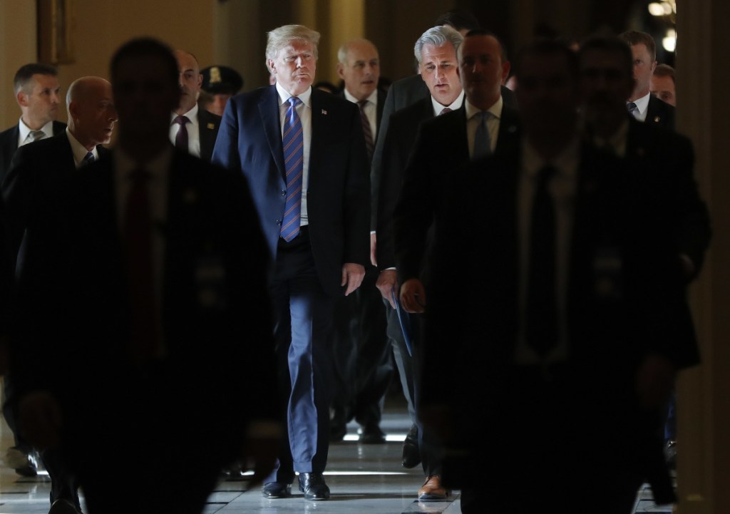President Trump walks with House Majority Leader Kevin McCarthy of California as he leaves the Capitol after meeting with Republican leadership on Tuesday. Walking behind them is White House Chief of Staff John Kelly.