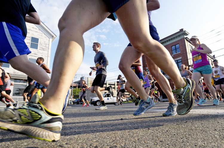 Runners make their way down Commercial St. near the start of the Old Port Half Marathon  on July 8, 2017.  (Staff photo by Shawn Patrick Ouellette)