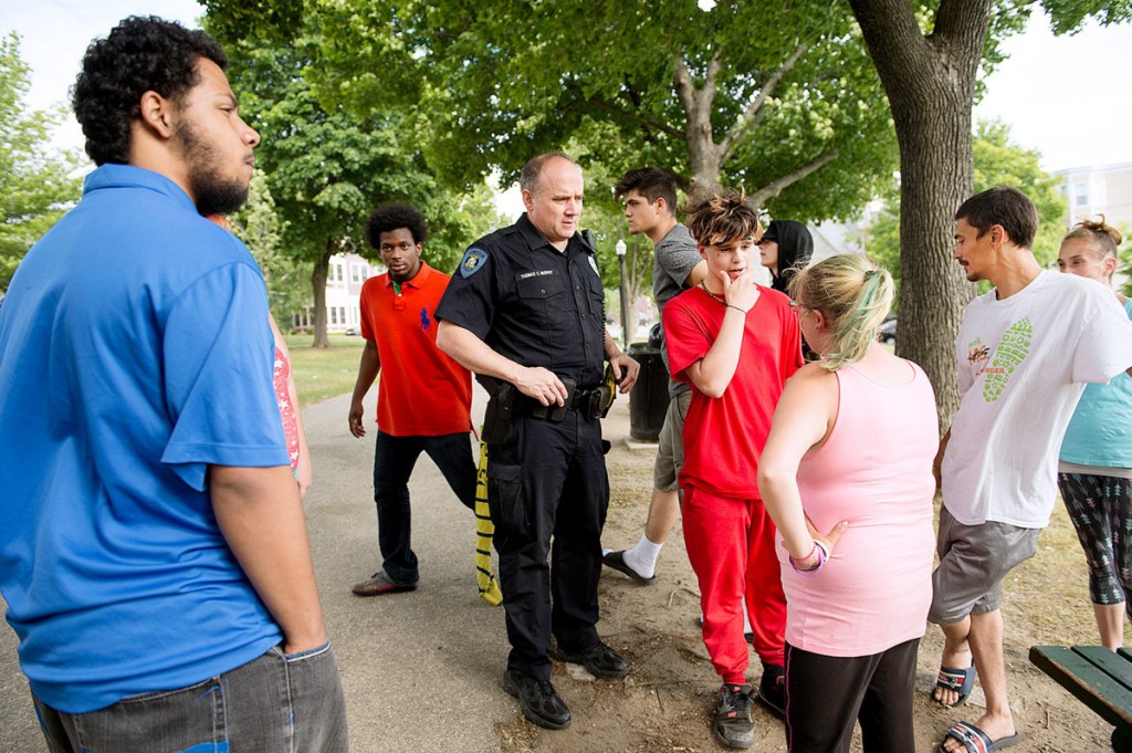 Lewiston police Officer Tom Murphy talks with people on June 13 about a brawl in Kennedy Park the previous night. Donald Giusti, 38, died Friday of injuries from the fight.