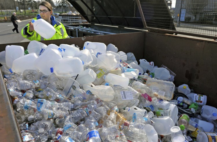Margo Gillaspy displays some of the recyclable plastic items that had been deposited at a transfer station in Mt. Vernon, Wash. 