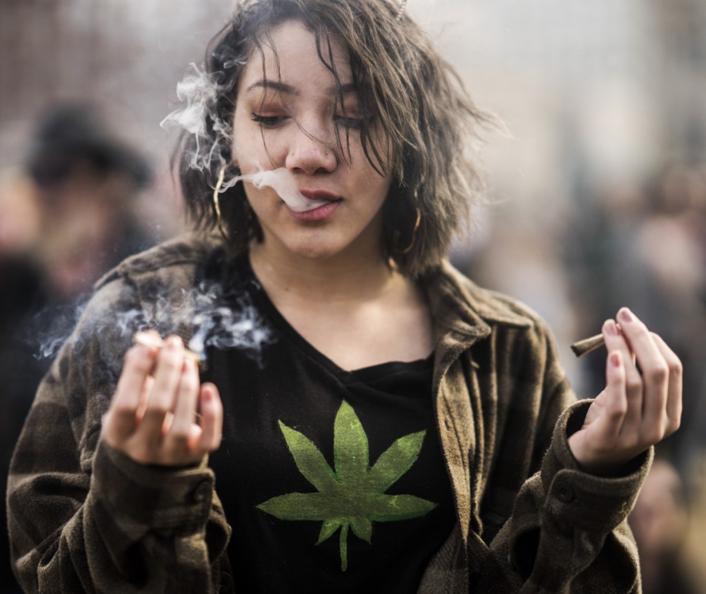 A resident smokes a marijuana joint during the 420 Day festival on the lawns of Parliament Hill in Ottawa, Ontario, Canada, in April 2018.