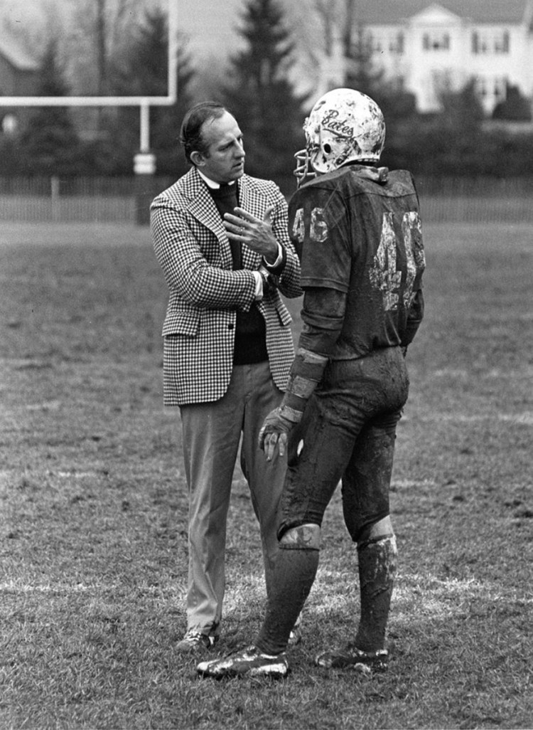 Web Harrison '63 talks with one of his Bates football players on Garcelon Field, circa 1982.