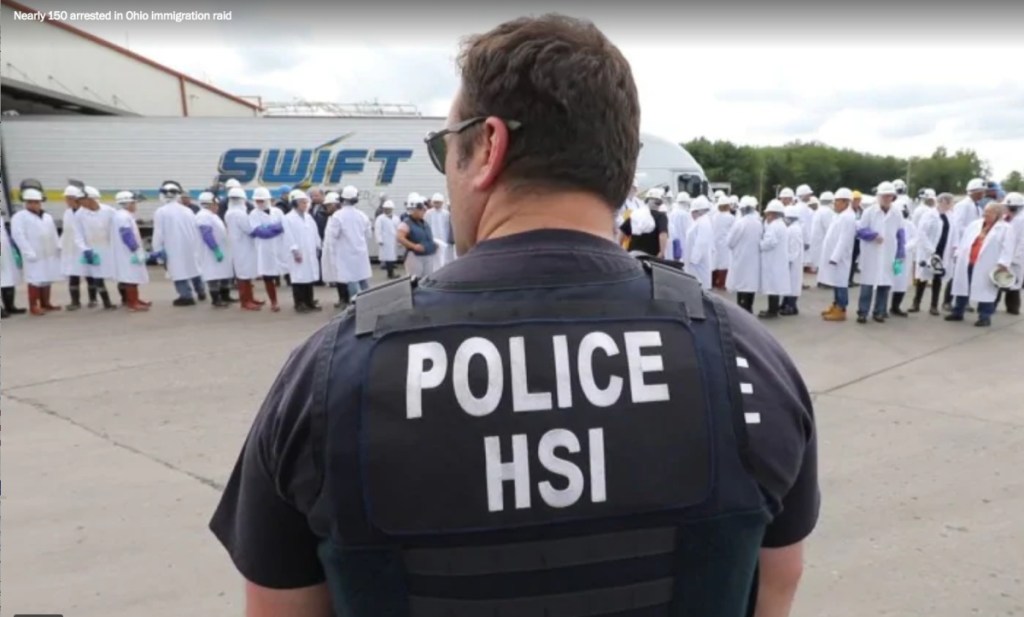 A Homeland Security officer stands in front of the Ohio meatpacking plant where 146 people were arrested Tuesday.