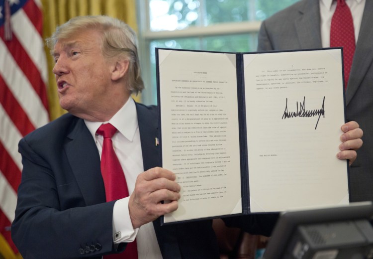 President Trump holds the order he signed Wednesday to end family separations at the border. A reader asks: Now that he has ended the abusive practice, will he take responsibility and apologize?