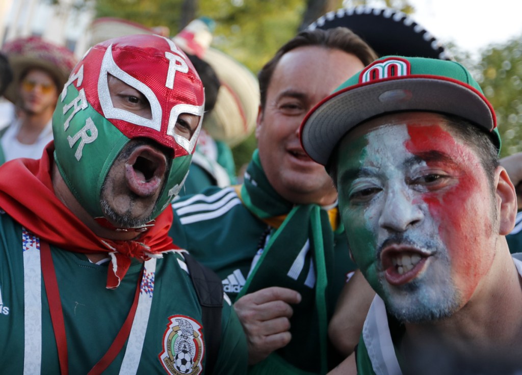 Mexico soccer fans celebrate their team's victory against Germany on Sunday. The country's football federation drew a fine for fans' use of a chant that's considered homophobic.