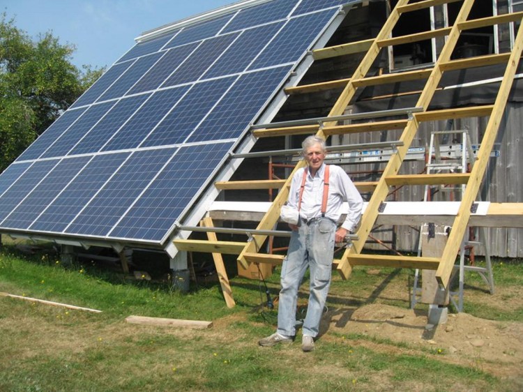 The humble Farmer finishes up the rack for his last eight solar panels. He now has 30 of them; his monthly electric bill is about $10 "for the convenience of being hooked to the grid."