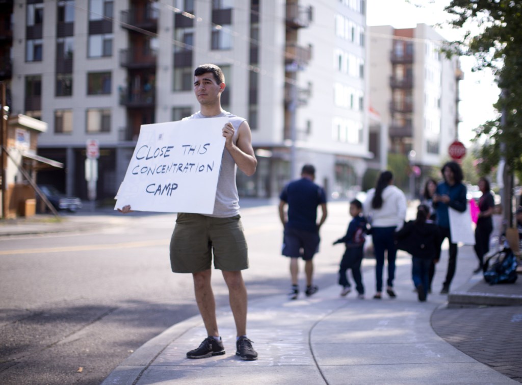 A protester takes part in a vigil earlier this week outside ICE headquarters in Portland, Ore. A rights group has filed an emergency suit in federal court against top officials of U.S. immigration and Homeland Security departments, alleging they have unconstitutionally denied lawyers' access to immigrants being held in a federal prison in Oregon.