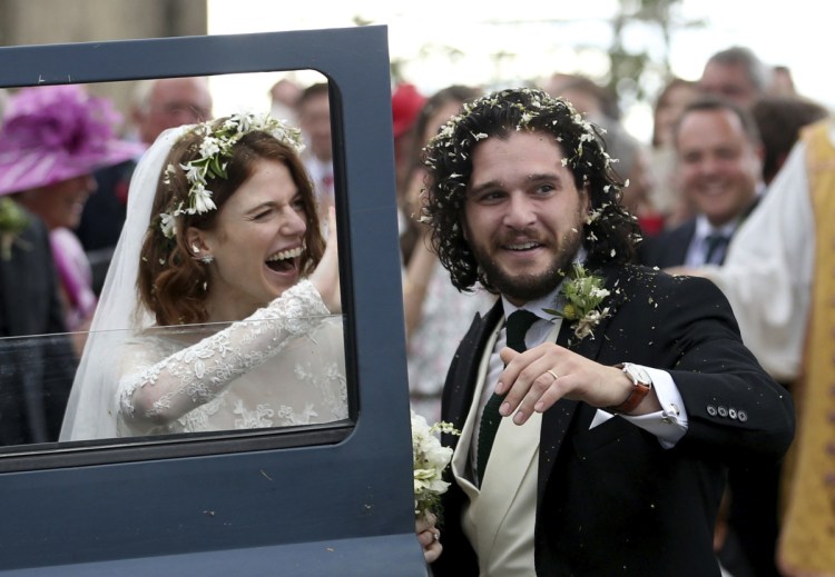 Actors Kit Harington and Rose Leslie leave the Rayne Church in Aberdeenshire, Scotland, after their wedding ceremony Saturday.