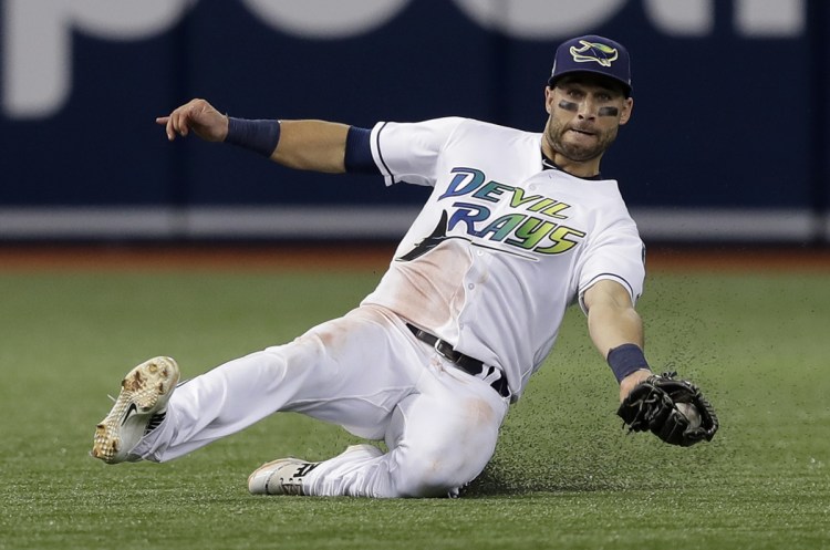 Tampa Bay center fielder Kevin Kiermaier makes a sliding catch on a flyout by the Yankees' Brett Gardner during the third inning their game in St. Petersburg, Florida, on Saturday. The Rays won 4-0.