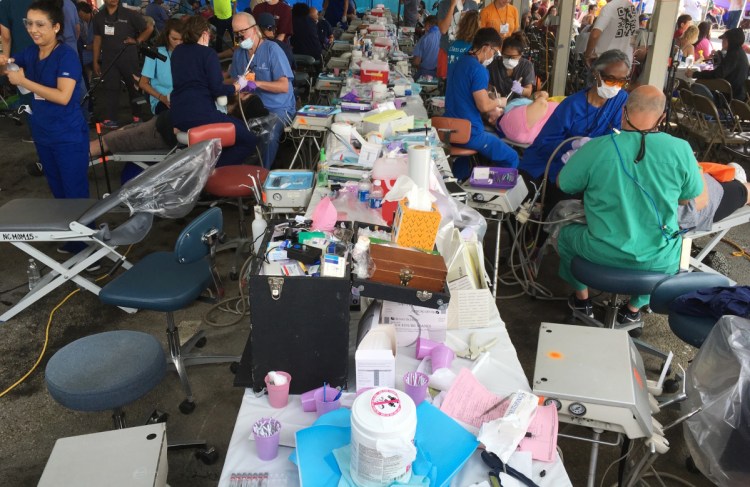 Low-income patients receive free medical and dental care in a tent at a weekend Remote Area Medical clinic in Wise, Va., in 2017. A new U.N. report calls out President Trump for policies that "seem deliberately designed to ... make even basic health care into a privilege."