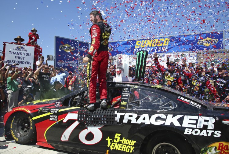 Martin Truex Jr. celebrates after his Cup Series victory Sunday at Sonoma Raceway in California. It was Truex's third win of the season, trailing only Kevin Harvick and Kyle Busch.