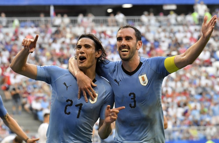Uruguay's Edinson Cavani celebrates with teammate Diego Godin, right, after scoring his team's third goal during their match against Russia at the 2018 soccer World Cup at the Samara Arena on Monday. ()