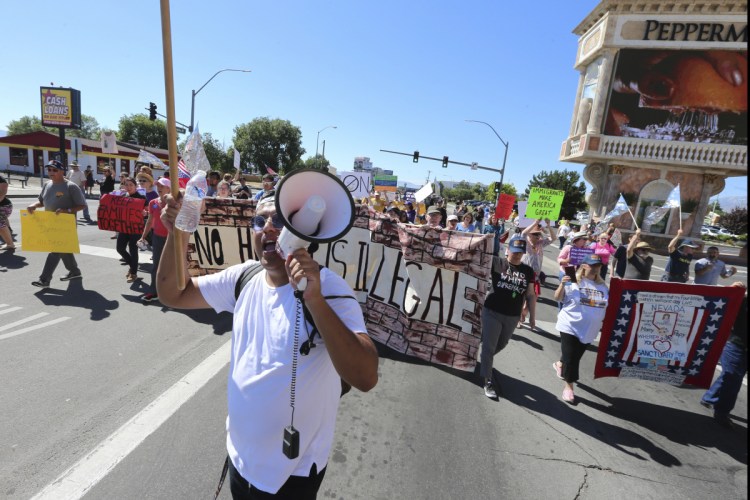 Protesters walk north on south Virginia street after demonstrating outside the Peppermill Resort-Casino in Reno, Nevada, where Attorney General Jeff Sessions spoke about immigration to a school safety conference on Monday.