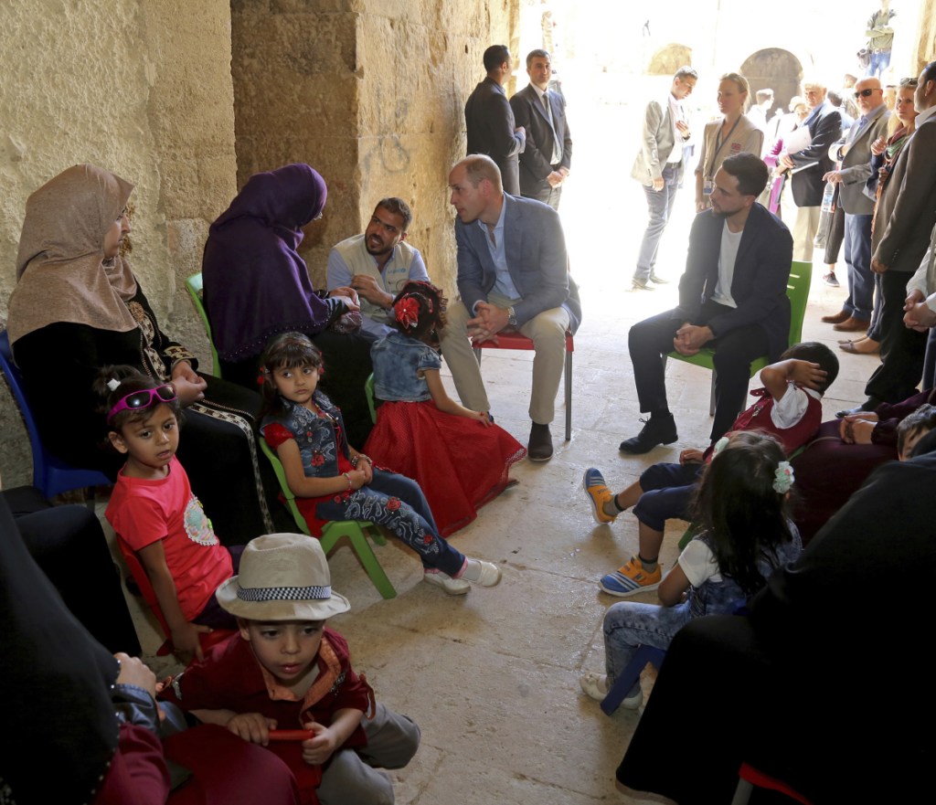 Prince William, center left, and Jordanian Crown Prince Hussain, center right, meet with people from an education and support program for Syrian and Jordanian children.