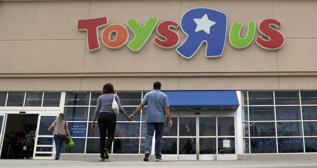 Shoppers walk into a Toys R Us store in San Antonio in September 2017. Toys R Us began liquidating its U.S. business earlier this year – and Party City wants to capitalize on it.