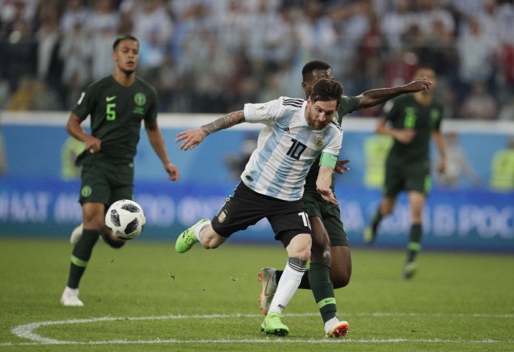 Argentina's Lionel Messi, front and Nigeria's Bryan Idowu, right, compete for the ball during the Group D match between Argentina and Nigeria on Tuesday in the St. Petersburg Stadium in St. Petersburg, Russia.